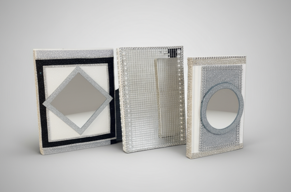 Three decorative boxes with unique designs on a light surface.