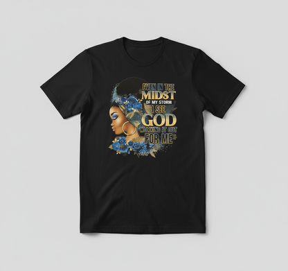 Woman wearing a white t-shirt with a graphic design and text, standing in a softly lit room.