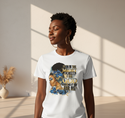 Woman wearing a white t-shirt with a graphic design and text, standing in a softly lit room.