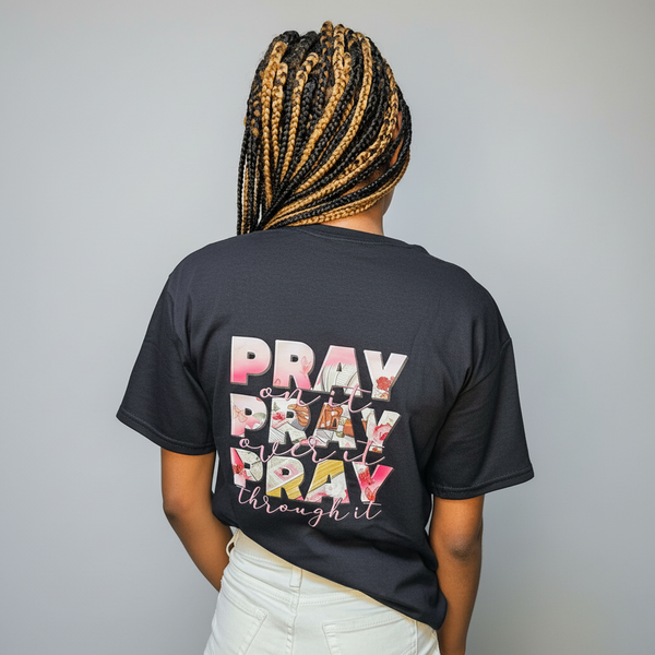 Person wearing a black t-shirt with colorful text on the back, standing against a plain background